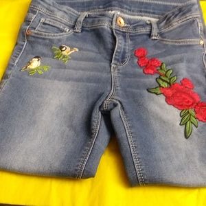Cute pair of 10-12 little girls jeans roses and birds on them used